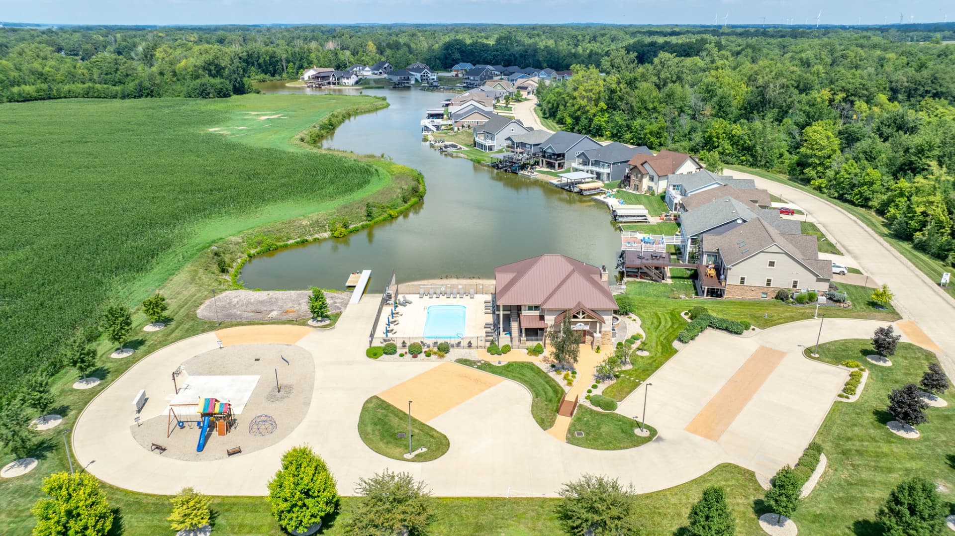 Aerial view of the clubhouse, pool, playground, canal and finished homes at Longview Cove, Indian Lake, Ohio